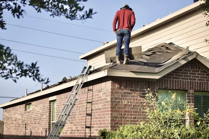 Professional roofer working on a residential roof in Luckie Marietta